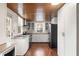 Spacious kitchen with stainless steel appliances, white cabinets, wood ceiling, and natural light at 1034 Orangeburg Rd, Summerville, SC 29483