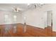 Bright living room featuring hardwood floors, neutral walls, a ceiling fan, and classic trim work at 1034 Orangeburg Rd, Summerville, SC 29483