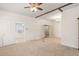 Open living area featuring carpet, white trim, and multiple entryways, offering a versatile living space at 1034 Orangeburg Rd, Summerville, SC 29483