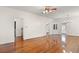 Living room features hardwood floors, white walls, a ceiling fan, and a built-in corner cabinet at 1034 Orangeburg Rd, Summerville, SC 29483
