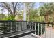 Comfortable black bench on a classic porch, providing a relaxing view of the vibrant garden and surrounding trees at 1034 Orangeburg Rd, Summerville, SC 29483