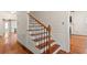Elegant staircase with wood treads, black iron balusters, and white risers, blending classic charm at 1034 Orangeburg Rd, Summerville, SC 29483