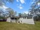 White brick home with a covered porch, stairs, and a spacious backyard at 107 Woodland Dr, Summerville, SC 29485