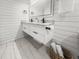 Modern bathroom featuring a double sink vanity, marble floors, and stylish fixtures at 107 Woodland Dr, Summerville, SC 29485