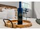 Close-up of a bottle of wine on a bed in a staged home for sale at 107 Woodland Dr, Summerville, SC 29485