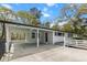 Attached carport with white brick walls, light blue ceiling, and concrete floor at 107 Woodland Dr, Summerville, SC 29485