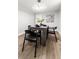 Dining room with modern lighting, wood table, four chairs, and wood floors at 107 Woodland Dr, Summerville, SC 29485