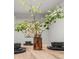 Dining room table setting with modern black plates and a decorative green leafy branch in the center at 107 Woodland Dr, Summerville, SC 29485