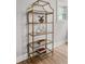 Stylish gold display shelves with glass shelving showcase decorative items and add elegance to the space at 107 Woodland Dr, Summerville, SC 29485