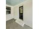 Inviting entryway with a classic black front door framed by white brick, enhancing the home's curb appeal at 107 Woodland Dr, Summerville, SC 29485