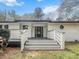 Inviting entryway with black door, white railings, and black porch deck at 107 Woodland Dr, Summerville, SC 29485