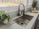 Modern kitchen sink with granite countertops and a stainless steel faucet and a large window at 107 Woodland Dr, Summerville, SC 29485