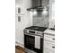 Modern kitchen features stainless steel oven, vent hood, white cabinets, and light countertops at 107 Woodland Dr, Summerville, SC 29485