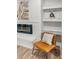 Cozy living room features an electric fireplace, built-in shelving, and a stylish mid-century modern chair at 107 Woodland Dr, Summerville, SC 29485