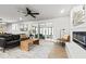 Modern living room with a leather sofa, wood accents, and a sliding glass door leading to a screened porch at 107 Woodland Dr, Summerville, SC 29485