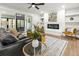 Living room features a fireplace, built-in shelving, modern decor, and ample natural light from sliding glass doors at 107 Woodland Dr, Summerville, SC 29485