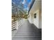 View of the dark deck and white railings from the side yard at 107 Woodland Dr, Summerville, SC 29485