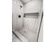 Close-up of marble-tiled shower featuring a shower niche and modern shower head at 107 Woodland Dr, Summerville, SC 29485