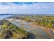 Expansive aerial shot of a coastal community featuring winding waterways, lush greenery, and distant city views at 1115 Barfield St, Charleston, SC 29492