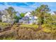 Aerial view of the backyard featuring waterfront views and a well-maintained yard with a trampoline at 1115 Barfield St, Charleston, SC 29492