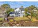 Aerial view showcasing a waterfront property with a large backyard, trampoline, and access to the water at 1115 Barfield St, Charleston, SC 29492