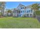 Expansive backyard with lush lawn and outdoor living spaces offers plenty of room for recreation at 1115 Barfield St, Charleston, SC 29492