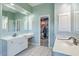 Bathroom with double sinks, cabinets, and a walk-in closet for maximum storage at 1115 Barfield St, Charleston, SC 29492