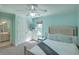 Cozy bedroom with light blue walls, ceiling fan, plush carpet, and ensuite bath provides a serene retreat at 1115 Barfield St, Charleston, SC 29492