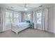 Sunlit bedroom featuring a twin bed, ceiling fan, and large windows with white curtains at 1115 Barfield St, Charleston, SC 29492