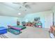 Large bonus room features a ceiling fan, ample space, and shelving for toys and gymnastic practice at 1115 Barfield St, Charleston, SC 29492