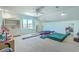 Spacious bonus room with built-ins, a large window for natural light, and gymnastics equipment for active play at 1115 Barfield St, Charleston, SC 29492
