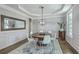 Elegant dining room with modern light fixture, hardwood floors, wainscoting, and a decorative ceiling at 1115 Barfield St, Charleston, SC 29492
