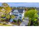 Beautiful two-story home featuring a welcoming front porch, two-car garage, and a manicured lawn with palm trees at 1115 Barfield St, Charleston, SC 29492