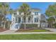 Charming two-story home with a welcoming front porch and well-manicured lawn and a bright blue front door at 1115 Barfield St, Charleston, SC 29492