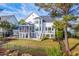 Backyard view of two-story home featuring a screened porch, decks, and fenced yard at 1115 Barfield St, Charleston, SC 29492