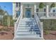 Inviting staircase leading to a charming porch with a vibrant blue ceiling and front door at 1115 Barfield St, Charleston, SC 29492