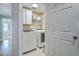 Convenient laundry room with modern washer and dryer units, cabinets, and shelving at 1115 Barfield St, Charleston, SC 29492