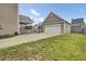 A sprawling backyard with a view of the detached garage and neighboring houses at 112 Tin Can Aly, Summerville, SC 29483