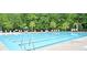 Community pool with lane markers, lounge chairs, tables and umbrellas on a sunny day at 112 Tin Can Aly, Summerville, SC 29483