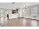 Bright dining area featuring wood floors, bar seating, and dark cabinets at 112 Tin Can Aly, Summerville, SC 29483