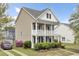Charming two-story home featuring a front porch, balcony, and lush landscaping at 112 Tin Can Aly, Summerville, SC 29483