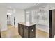 Bright kitchen with a dark kitchen island, tile floors, stainless steel appliances and access to the backyard at 112 Tin Can Aly, Summerville, SC 29483