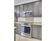 Updated kitchen with stainless steel appliances and grey cabinets at 112 Tin Can Aly, Summerville, SC 29483