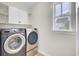 Laundry room with new washer and dryer and built-in shelving at 112 Tin Can Aly, Summerville, SC 29483