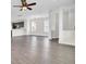 Open living area featuring wood floors, white trim, ceiling fan, and kitchen view at 112 Tin Can Aly, Summerville, SC 29483