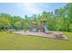 Community playground with wooden play structure, swings, and wood chip ground cover on a sunny day at 112 Tin Can Aly, Summerville, SC 29483