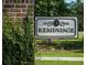 Community sign for Reminisce with brick and vine detail near green landscaping at 112 Tin Can Aly, Summerville, SC 29483