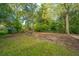 Large backyard featuring mature trees and greenery at 1121 Inverness Ln, Hanahan, SC 29410
