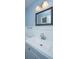 Bathroom with blue walls featuring a framed mirror above a white sink and vanity at 1121 Inverness Ln, Hanahan, SC 29410