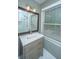 Bathroom with a single sink vanity and mirror and large window at 1121 Inverness Ln, Hanahan, SC 29410